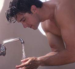 mens skin care - a man washing his face