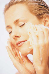woman applying an anti-aging face cream