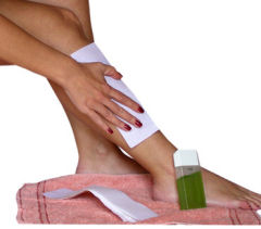 waxing hair removal treatment on leg