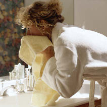 woman drying face after applying the best anti aging product