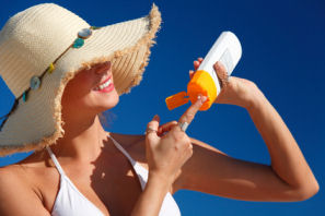 woman applying spf moisturizer for sun skin protection